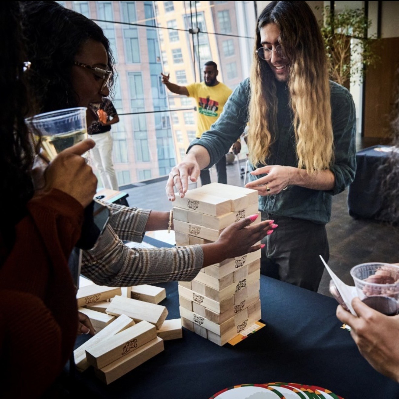 Black @ L'Oréal team playing giant Jenga at a cultural activation