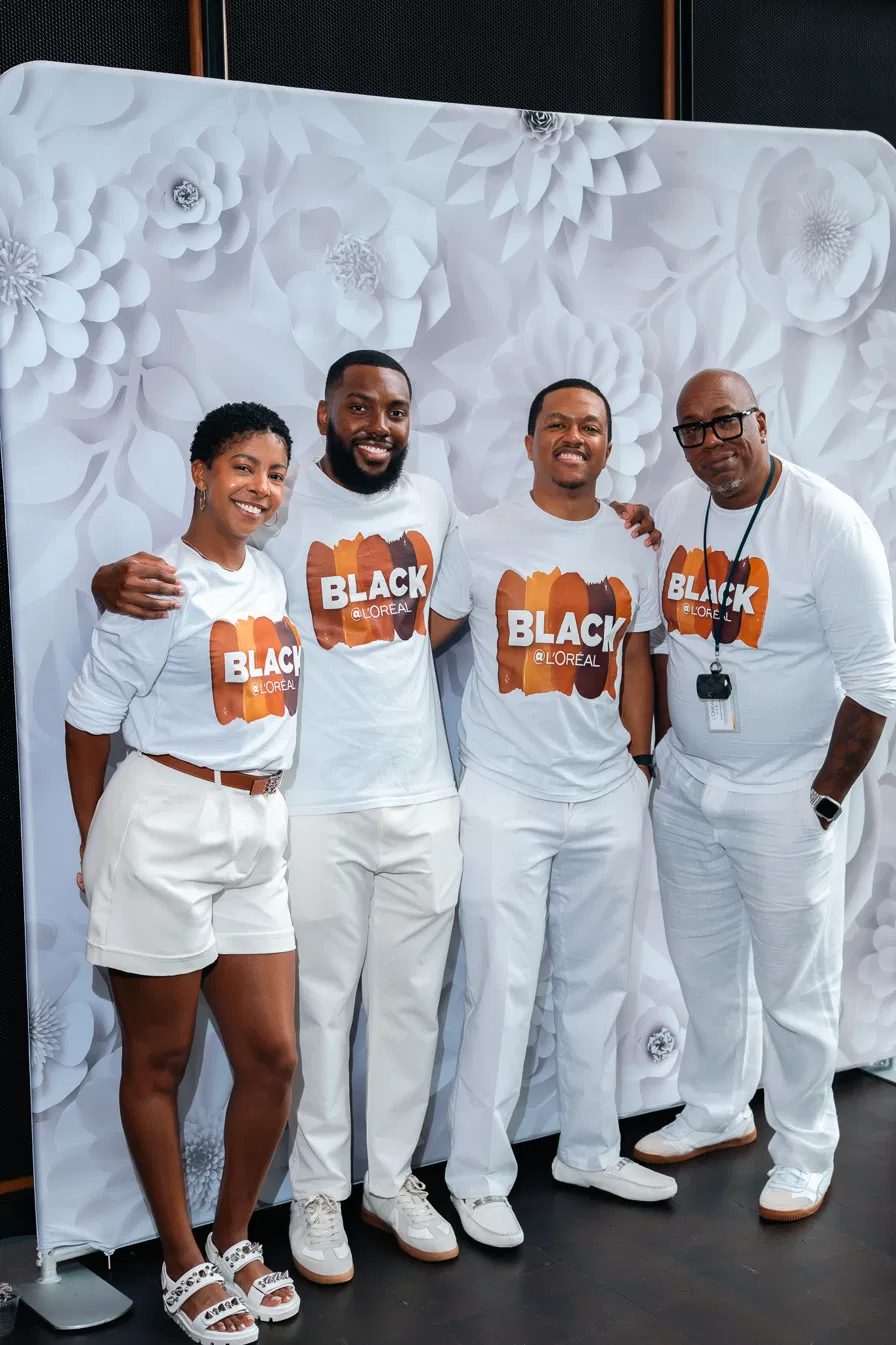 Black @ L'Oréal team in branded tees at an event